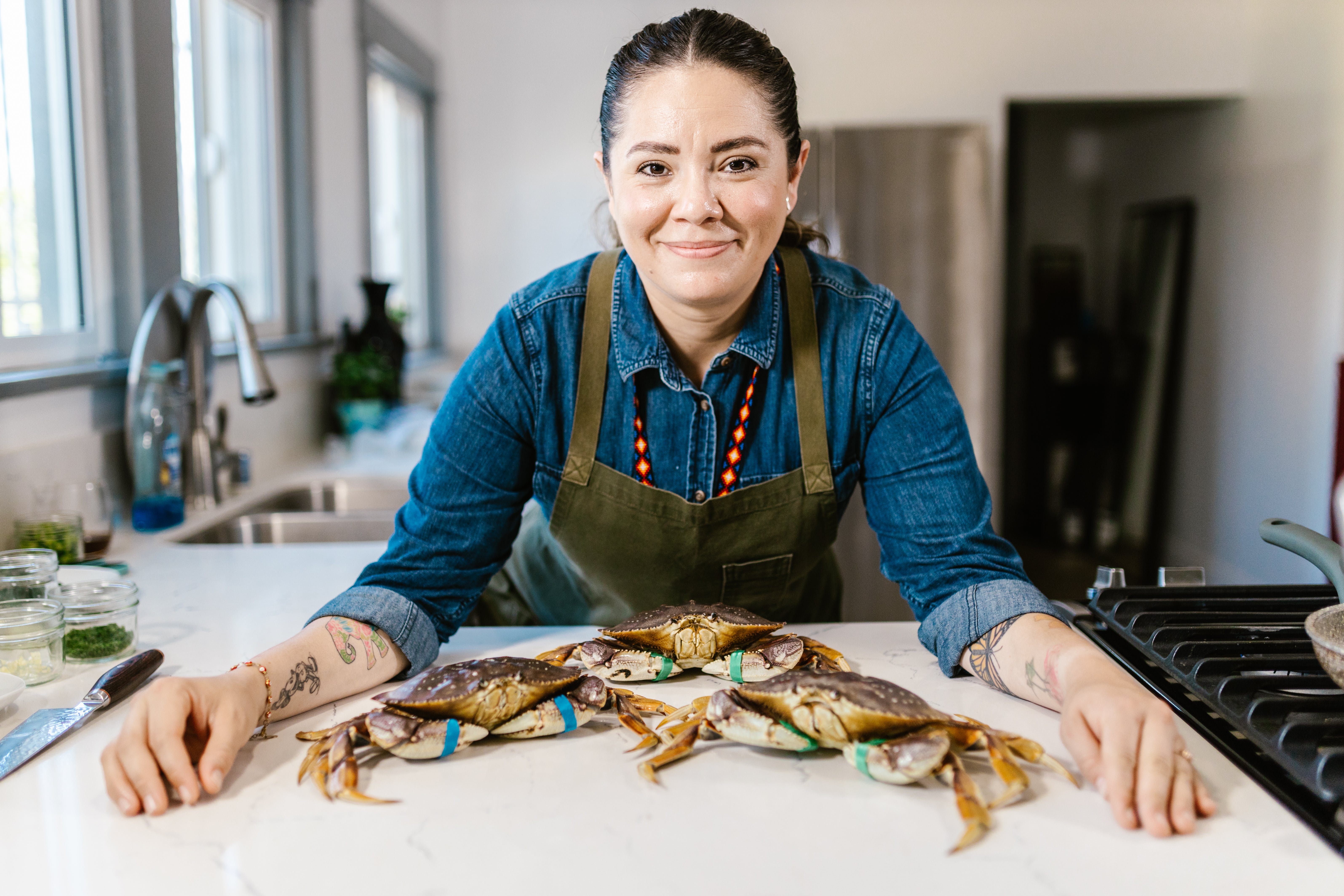 image of a lady chef with crabs on the table